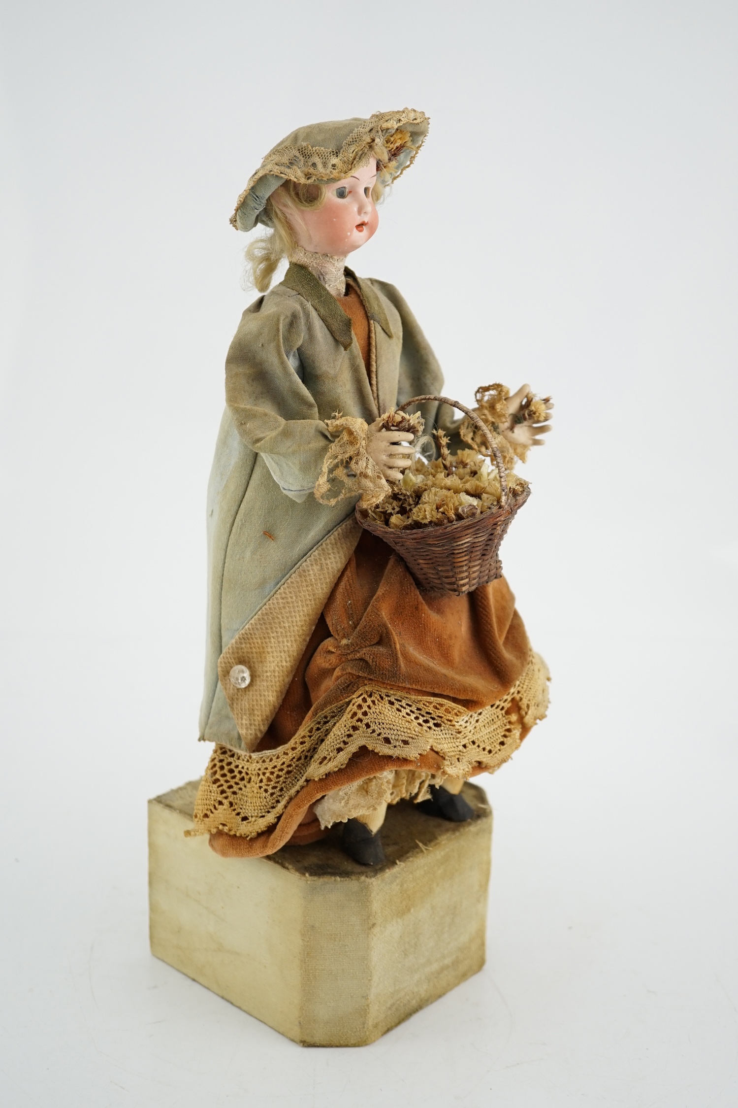 A German automaton of a flower seller, 39cm high